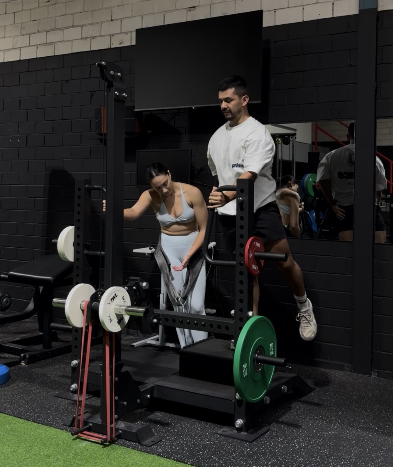 Coach spotting a client during a lift at WSF studio